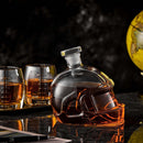The Craftgen Football Whiskey Decanter by Craftgen, shaped like a helmet and filled with whiskey, sits beside two football-stitched glasses—a perfect gift and standout barware for any game day setup. A yellow globe adds extra charm in the background.