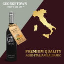 A bottle of Georgetown Olive Oil Co. CUCUMBER MELON White Balsamic Vinegar | Barrel Aged, Modena ITALY is displayed beside a gold map of Italy with the text "PREMIUM QUALITY AGED ITALIAN BALSAMIC," emphasizing its genuine Modena, Italy balsamic heritage.