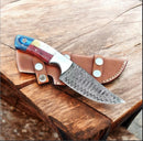 The Texan Knives Custom Handmade Texas Flag Damascus Steel Hunting Knife with exotic wood-bone handle rests on a brown leather sheath atop a rustic wooden table.