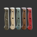Five sustainable Messermeister Custom Indigo Mod Kit Handles—crafted from repurposed wood in gray, beige, green, brown, and red—are arranged vertically. Each handle has three holes for easy attachment to your knife blade.