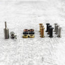 The Messermeister Custom Mod Kit Handle Hardware features assorted gold, copper, black, and silver pieces plus two screwdriver bits, all neatly arranged—perfect for upgrading your knife handle.