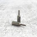 Two metallic Messermeister Custom Mod Kit Handle Hardware bits with hexagonal bases are shown on a textured gray surface. Designed for knife handle upgrades, both feature star-shaped tips—one upright, one lying flat.