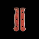 Two Messermeister Custom Terra Mod Kit Handles (Medium), made from sustainable repurposed wood shavings, with curved edges and three screw holes each, are shown side by side on a black background.
