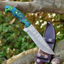 The Texan Knives Custom Handmade Damascus Skinning Knife features a 4.5" blade and a green-blue swirled resin handle, paired with a brown leather sheath with white stitching and metal accents—ideal for seasonal hunts.