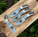 Four Texan Knives Custom Handmade Guthook Hunter Knives, each crafted with Damascus steel and a stag horn handle, are arranged on a wooden board.