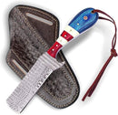 The Texan Knives Custom Handmade Bull Cutter Knife features a patterned Damascus steel blade and a blue, red, and cream-toned Pakkawood & camel bone handle, resting on a brown leather sheath with decorative stitching and strap.