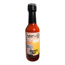 A bottle of Culture Hot Sauce Czech'd Out by Culture Hot Sauce, a special collaboration with Boomtown Brewing, features a vibrant label with beer glasses and bottles. This unique Czech Pilsner hot sauce blends craft beer culture with bold and spicy flavors.