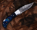 The Texan Knives Personalized Damascus Steel Pocket Knife features a Damascus folding blade and blue swirled handle—an ideal custom Valentine's Day gift for your husband or collectors.