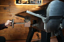 A person pulls the smoke box handle out from the front of a pellet grill featuring a Pimp My Grill® Tactical Stainless Folding Front Shelf.