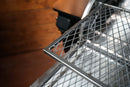 Two stacked metal grate shelves of the Pimp My Grill® Gen2 Slide-Out Rack System for Camp Chef Woodwind 24 / Woodwind Pro 24 / CL 24 extending from a grill interior.