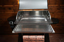 Pellet grill with its lid open, featuring two extended Pimp My Grill® Gen2 Slide-Out Rack System - 2 Racks and a roll of branded butcher paper resting on the front shelf.