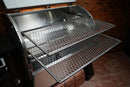 Two metal wire Pimp My Grill® Gen2 Slide-Out Rack System racks extended outward from the open lid of a pellet grill to expand cooking capacity.