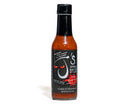 A bottle of California Hot Sauce Solutions J's Small Batch The Exorcist Hot Sauce featuring a black label with red, evil-looking eyes and text emphasizing no sugar and no preservatives.