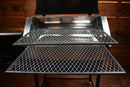 Two stacked metal slide-out grill racks from the Pimp My Grill® Gen2 Slide-Out Rack System for Recteq RT-590 forming a two-level cooking station inside a pellet grill.