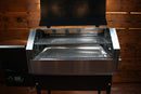 Open Recteq RT-590 pellet grill featuring a Pimp My Grill® Gen2 Slide-Out Rack System with two levels of slide-out metal diamond-pattern grates.