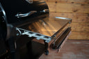 Stainless steel Pimp My Grill® Tactical Stainless Folding Front Shelf attached to a Recteq Deck Boss 590 pellet grill, featuring a paper towel holder rack underneath.
