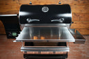 Black Traeger Pro 34 pellet grill with a Pimp My Grill® Tactical Stainless Folding Front Shelf attached to the front.