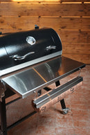 Pimp My Grill® Tactical Stainless Folding Front Shelf for the Recteq Patio Legend 410, featuring an integrated paper holder with a roll of butcher paper to provide convenient grill prep space.