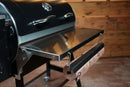 Pimp My Grill® Tactical Stainless Folding Front Shelf attached to a Recteq Patio Legend 410, featuring a paper dispenser holding a roll of butcher paper for added grill prep space.
