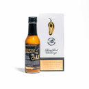 A bottle of California Hot Sauce Solutions J's Small Batch Raisin the Bar Hot Sauce stands next to a white trophy with a gold chili pepper and a plaque reading Spicy Food Challenge, California Hot Sauce Solutions, 2023.