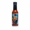 A bottle of California Hot Sauce Solutions J's Small Batch The 5th Henchman Hot Sauce from California Hot Sauce Solutions features a vibrant, fiery label with playful cartoon characters. Inside, the dark red sauce showcases the bold flavors of Carolina Reaper and Scorpion pepper. The bottle is topped with a black cap and set against a white background.