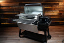 A Traeger Ironwood XL with an open lid, featuring two Pimp My Grill® Gen2 Slide-Out Rack System racks extended from its multi-level cooking platform.