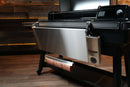 Pimp My Grill® Tactical Stainless Folding Front Shelf attached to a Traeger Ironwood XL pellet grill, featuring an integrated paper towel holder for convenient prep space.