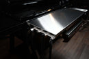 Pimp My Grill® Tactical Stainless Folding Front Shelf for Traeger Ironwood XL attached to a grill, serving as extra prep space with notches along the front edge for hanging grilling tools.