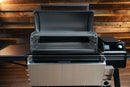A black Traeger Ironwood XL pellet grill with the Pimp My Grill® Gen2 Slide-Out Rack System installed, featuring its lid open to reveal two stacked, slide-out racks in a multi-level cooking platform.