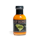 A bottle of California Hot Sauce Solutions Hip Bone South Carolina BBQ Sauce, featuring an orange-hued sauce inside. The label displays a map of South Carolina with various place names and the phrase "Connected to your mouth bone," perfectly capturing the essence of a mild habanero BBQ and celebrating the tradition of South Carolina barbecue sauce.