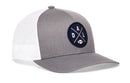 The Haka Hat Dallas Trucker Hat in gray and white features a black patch with crossed lines, "D", "A", "L" letters, and a football icon. This signature Haka Hat snapback combines style and comfort.