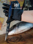 Dalstrong Filled knife 4.7" Night Shark Series pictured with fish. 