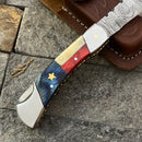 The Texan Knives Damascus Steel Pocket Knife features a 3" blade and a Texas flag-inspired handle accented with a gold star. It comes with a stitched leather sheath, blending patriotic style with expert craftsmanship.