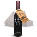 A bottle of Georgetown Olive Oil Co. Dark Chocolate Balsamic Vinegar, featuring a maroon cap and a white Georgetown Olive Oil Co. logo, with a brown tag, is displayed in front of chocolate pieces.