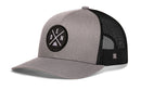 The Haka Hat Denver Trucker Hat in gray-black features a mesh back, snapback closure, and a front round patch with crossed lines, “D” and “EN” letters, and a mountain graphic.