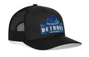The Haka Hat Detroit Motor City Trucker Hat features a black snapback design with blue cityscape embroidery, Motor City Detroit Michigan text, and a blue bridge patch on the front.