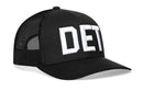 The Haka Hat Detroit White Block Trucker Hat is a black mesh snapback with "DET" in large white embroidery and the HAKA 5.0 design, perfect for showing Michigan pride.