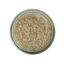 A top-down view of a glass jar filled with SALTOPIA Infused Sea Salts Truffle Salt, White Italian Truffles: DIRTY WEDDING—coarse, light brown salt crystals infused with luxury Italian white truffles, isolated on a white background.