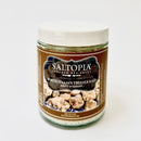 A 4 oz jar of SALTOPIA Infused Sea Salts' DIRTY WEDDING Truffle Salt, with a white lid and brown label showing Italian white truffles, delivers gourmet flavor with premium White Italian Truffles.