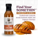 A bottle of B.T. Leigh’s Mustard Maple Rosemary BBQ Sauce beside two grilled chicken breasts drizzled with the Carolina-inspired barbecue sauce, featuring text promoting the product.