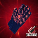 A pair of black Butcher BBQ Extreme Heat Resistant Cooking Gloves with red grip dots and logo, shown on a red background with another Butcher BBQ logo in the corner. Ideal for grilling or smoker use.