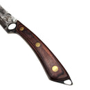 A close-up of the Spaceman Knives Meteor Series Boning Knife, featuring a wooden handle with three brass rivets, rests on a marble-patterned surface beside black fabric—ideal for precision kitchen prep.