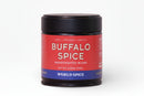 A jar of World Spice Buffalo Spice from World Spice, adorned with a red and blue label detailing the product and topped with a black lid, is shown against a plain white background—ideal for making your own bold wing sauce with its signature cayenne garlic flavor.