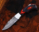 The Texan Knives Personalized Damascus Steel Pocket Knife, a custom Valentine's Day gift, features a polished handle with red and black accents. This elegant EDC folding knife combines intricate design with personalized craftsmanship.