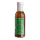 A glass bottle filled with a brown liquid and topped with a white cap features Hickman's BBQ branding and a green label detailing the ingredients and instructions for use. This is Hickman's Divine Swine Pork Injectable Marinade with Injector, the perfect choice to elevate your smoked pork—designed specifically for use with a marinade injector. Even if some details on the label are difficult to read from this angle, you can trust that this product will enhance your next barbecue.
