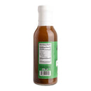 Hickman's BBQ Divine Swine Pork Injectable Marinade Pack of 2 features glass bottles with white caps, each filled with a rich brown marinade. The back showcases a green label displaying nutrition facts and a barcode. Standing upright against a white background, this product from Hickman's BBQ is perfect for BBQ enthusiasts looking to add bold flavor to smoked pork.