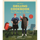 Two men in aprons stand in a grassy yard next to a charcoal grill and a lawn chair on the cover of The Best Grilling Cookbook Ever Written by Two Idiots - Paperback.