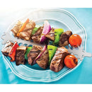 Skewer of grilled meat and vegetables on a white plate with a blue background