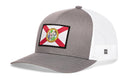 The Haka Hat Florida Flag Trucker Hat | Black FL Snapback features a state flag and seal patch, black front and brim, white mesh sides and back, plus an adjustable snapback closure. Brand: Haka Hat.