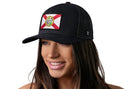 A woman with long brown hair smiles while wearing the Haka Hat Florida Flag Trucker Hat, a classic gray-black FL snapback featuring the state flag on a crisp white front.